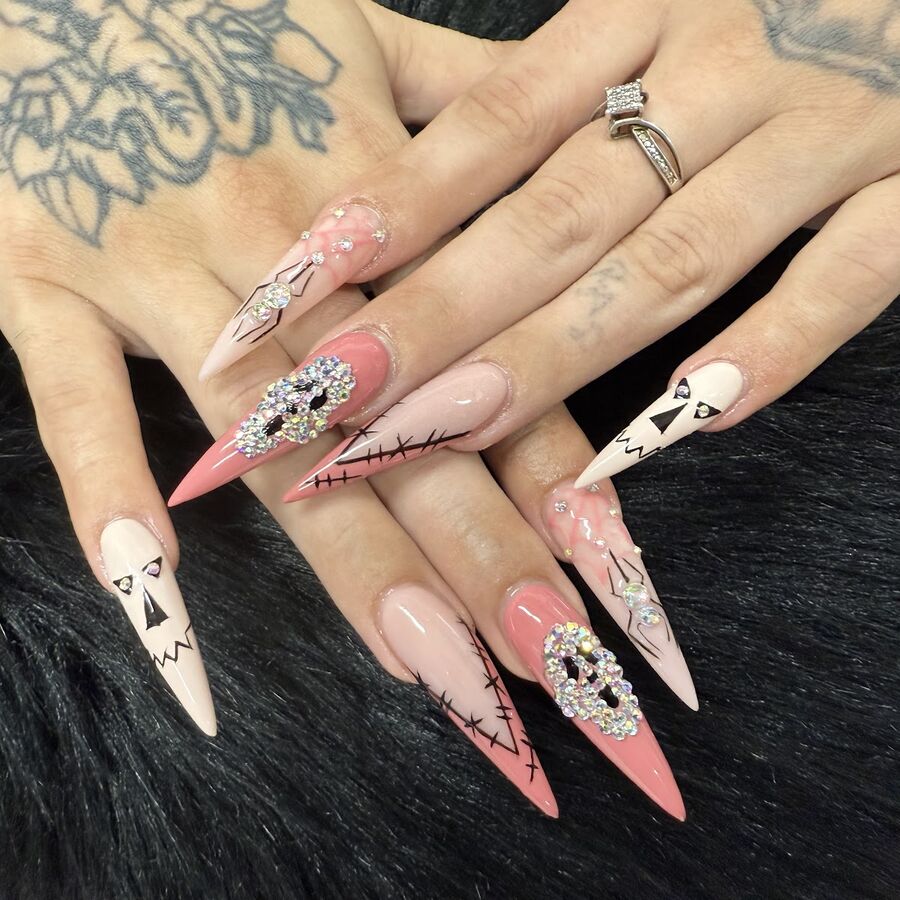 Pink and white stiletto nails with hand-painted art