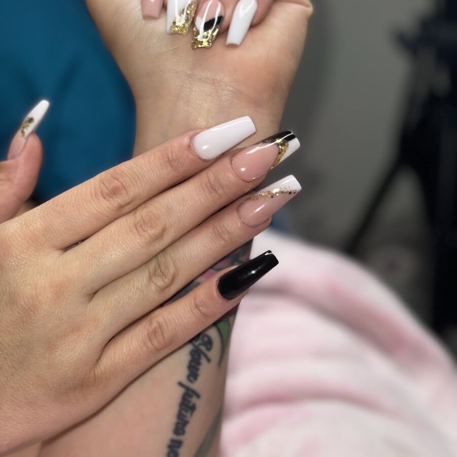 A white and black set with gold detail on long square nails
