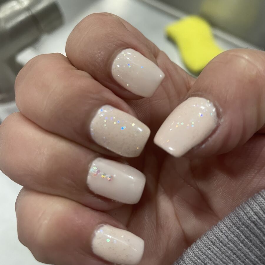 A nude set with fine glitter across the tips